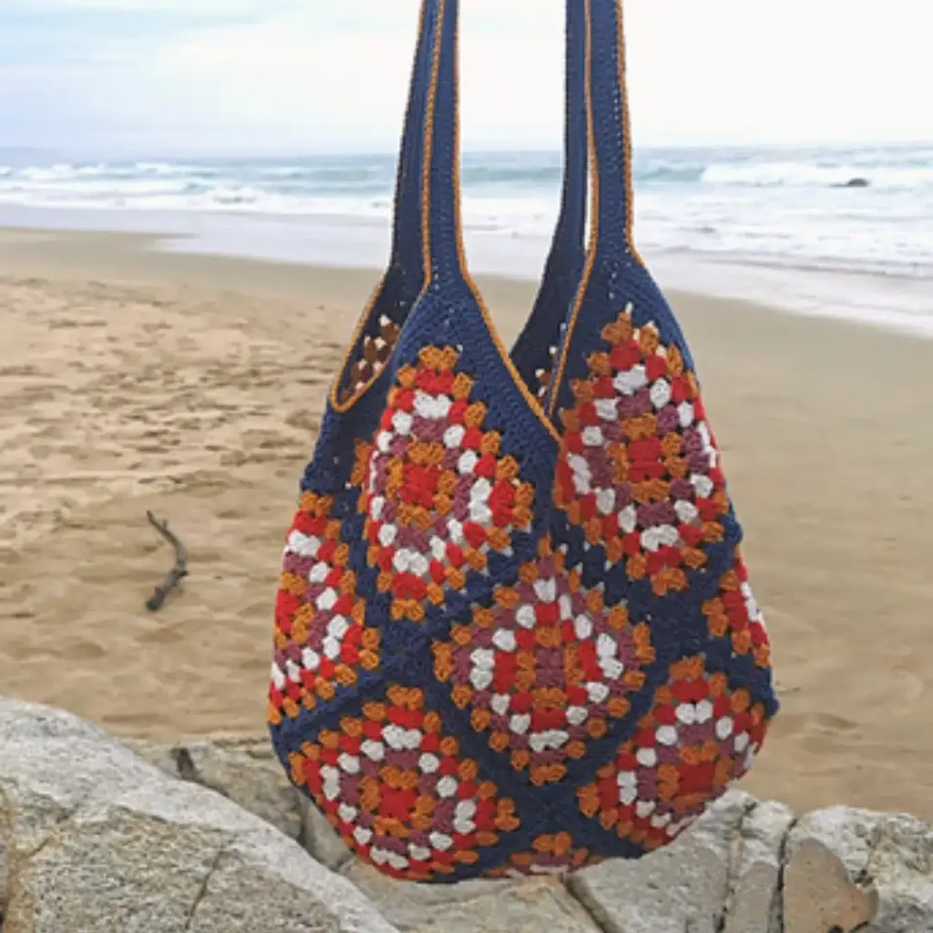 50+ Fabulous Free Bag Patterns 45 13 granny squares, stitched with Kismet Yarn Raeesah Cotton into a trusty 15x15.7-inch tote for shopping or WIPs.