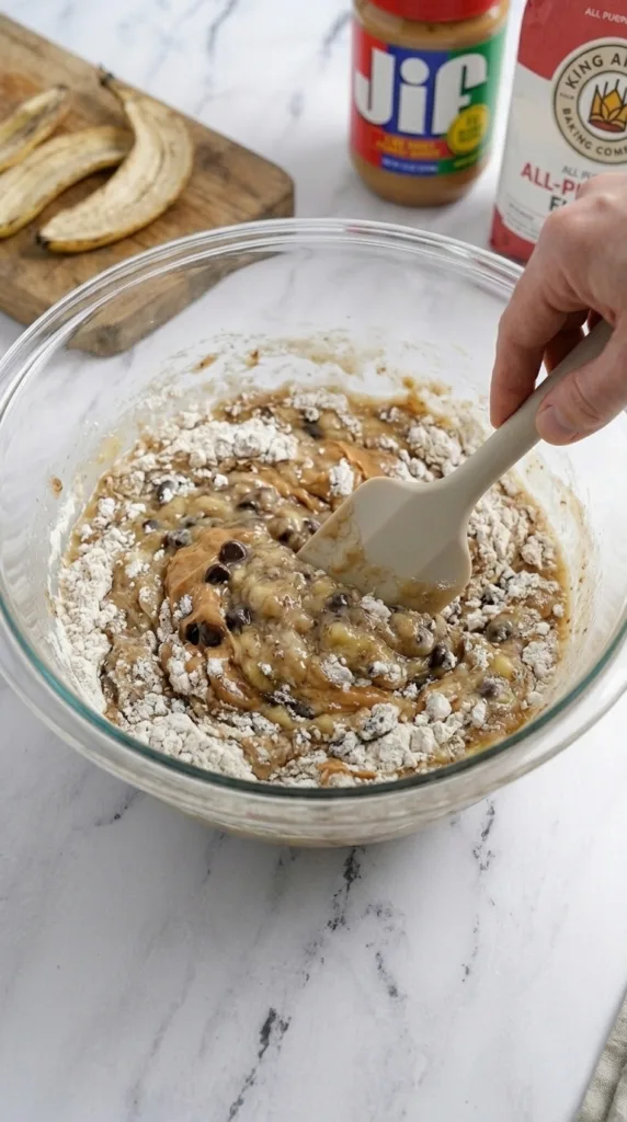 Combining wet and dry for peanut butter banana bread batter