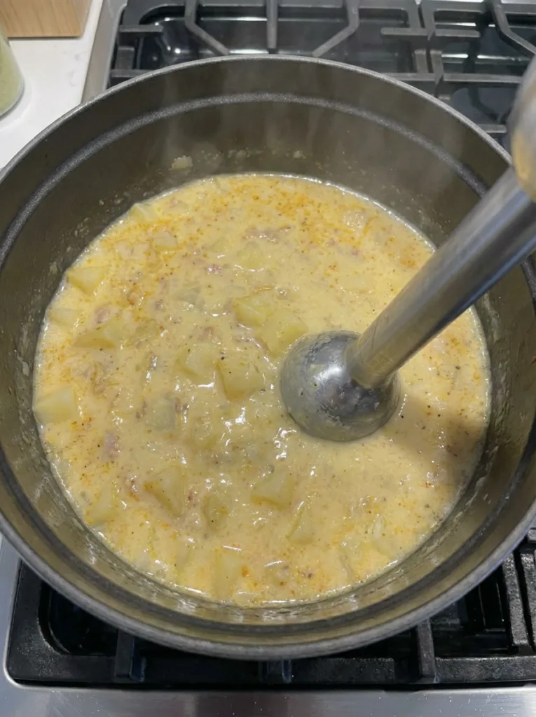 Blending half the potato soup for creamy texture