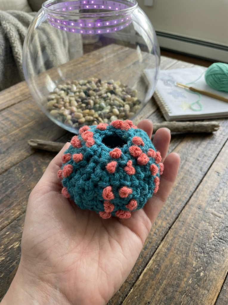 Crochet sea urchin made with worsted weight yarn featuring textured French knots