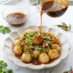 Chewy potato balls with spicy garlic sauce, showing QQ texture