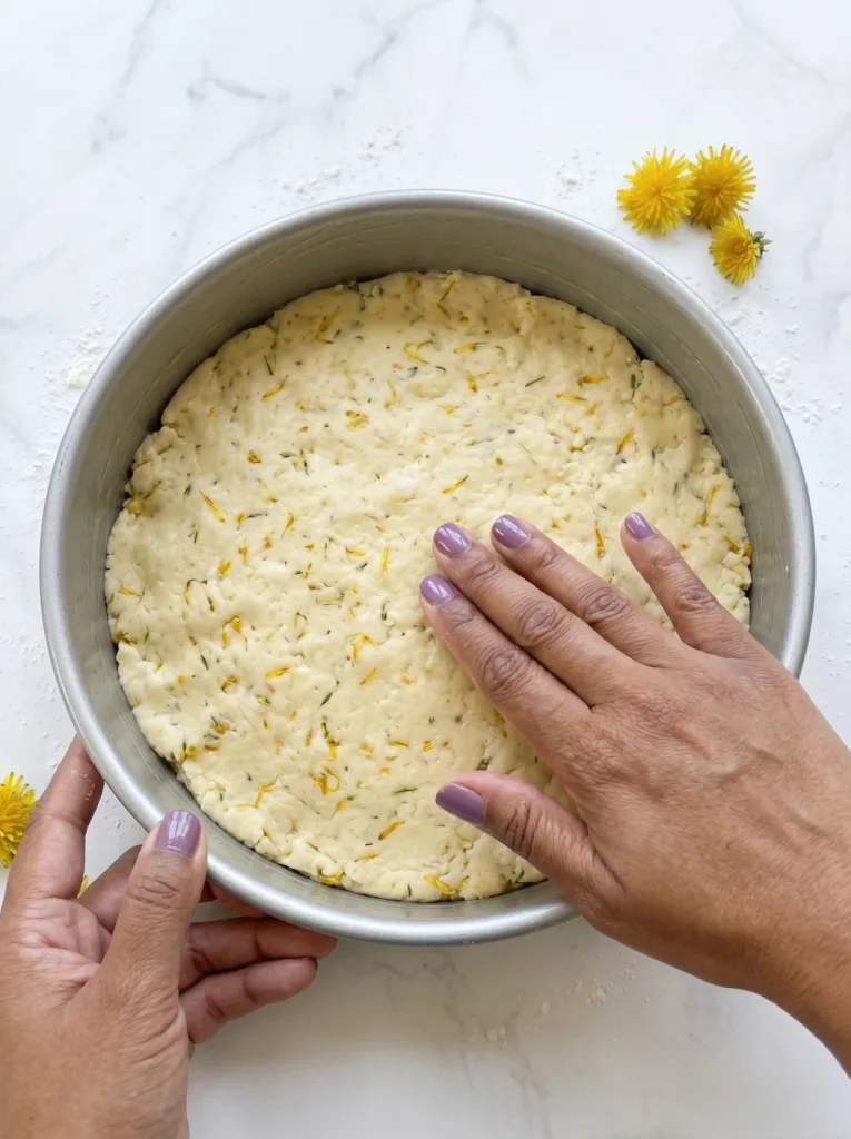 Dough pressed evenly into 9 inch cake pan to form uniform round shape before cutting