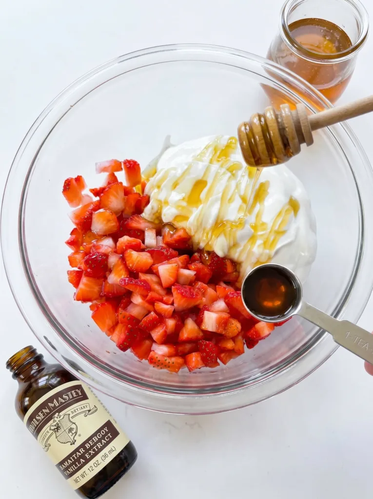 Ingredients for chocolate strawberry yogurt clusters in a bowl before combining