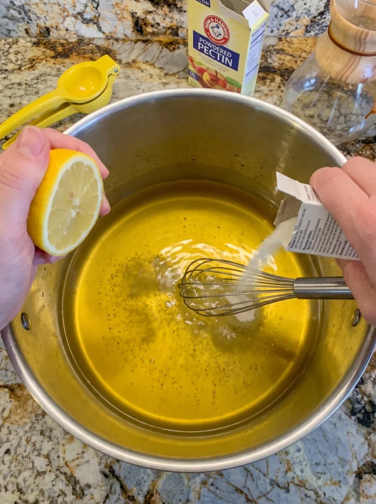 Lemon juice added to dandelion tea brightening color for dandelion jelly