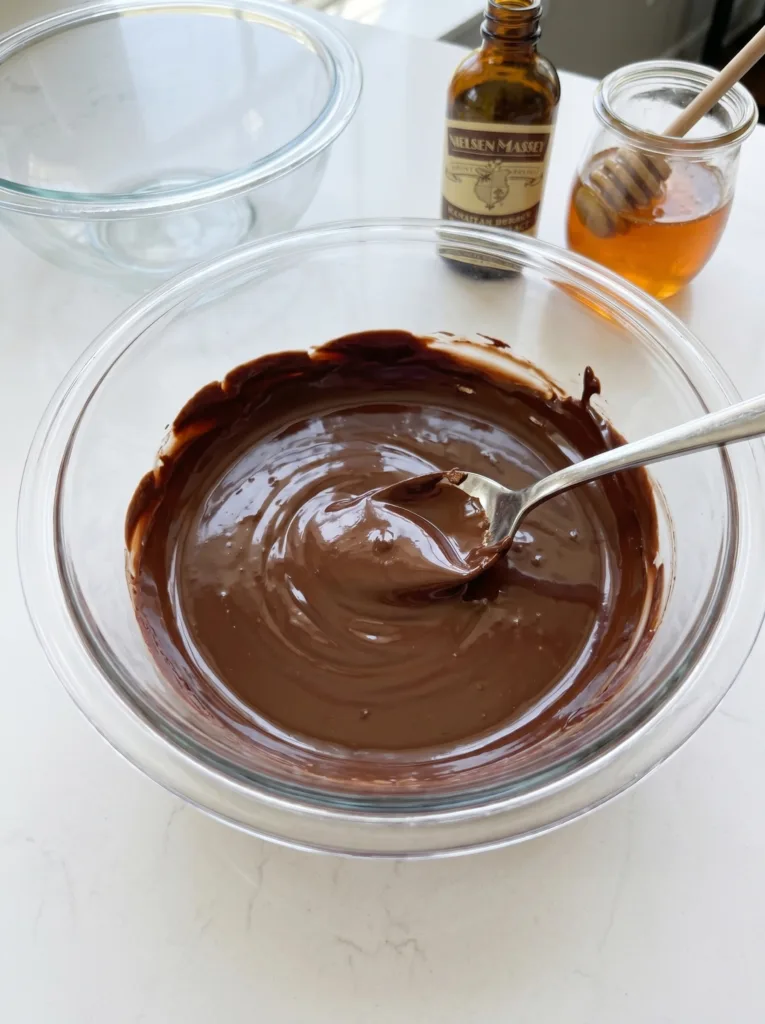 Melted semi-sweet chocolate with coconut oil for coating frozen yogurt clusters
