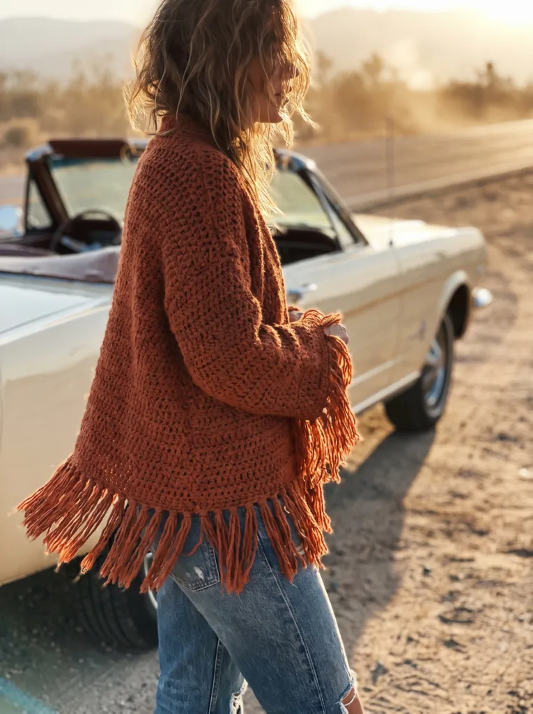 Crochet boho cardigan in terracotta with relaxed fit and fringe hem and cuffs
